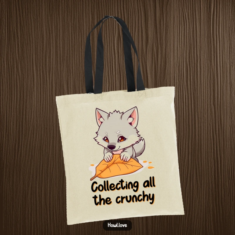 Funny tote bag with a cartoon wolf playfully pouncing on a single autumn leaf, showcasing energetic and humorous style for daily use.